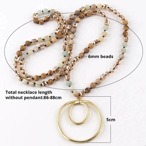 Detail of 6mm beaded necklace with double gold ring pendant and 88cm length