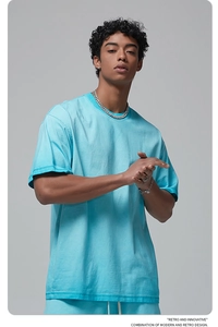 Detail view of light blue cotton t-shirt fabric texture and dropped shoulder tailoring