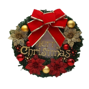 Festive Christmas wreath featuring a red velvet bow, gold flowers and Merry Christmas sign