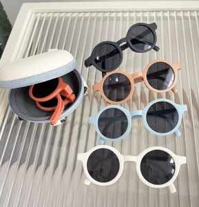 Foldable round kids sunglasses in candy colors with matching circular zipper hard case