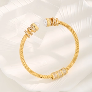 Gold open bangle with pearl accents, twisted rope design and sparkling cubic zirconia