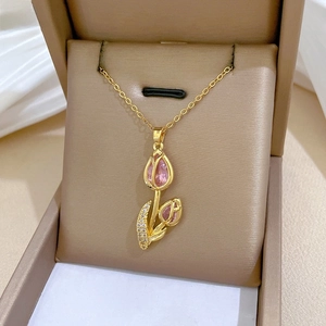 Macro detail of tulip pendant with pink crystals and micro-pavé diamonds in a jewelry box