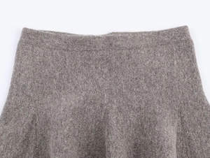 Close-up of the grey wool-feel skirt waist and knit texture detailing