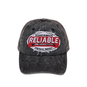 Detailed close-up of dark grey washed cotton baseball cap with Reliable vintage embroidery
