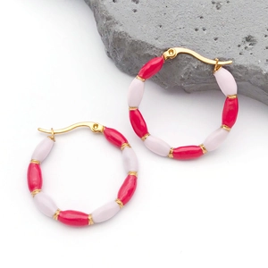 Detail of bamboo joint earrings with red and pink enamel beads and gold plating