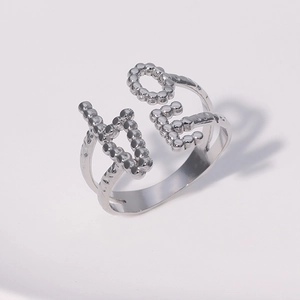 Detailed close-up of silver LOVE letter ring with minimalist adjustable open band design