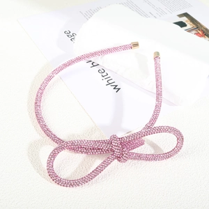 Macro detail of sparkly pink rhinestone headband with a large stereoscopic bow ornament