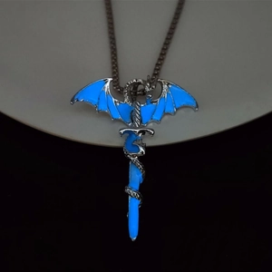 Macro view of luminous dragon sword pendant with blue glowing effect on silver metal base