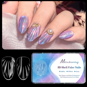 Macro detail of 3D shell texture almond nail tips with pearl and golden accents