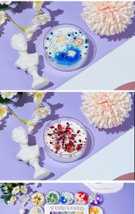 Close-up of scented jelly candle with shells, dried flowers and sparkles in glass