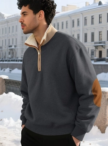 Detail of men's quarter-zip sweatshirt with brown elbow patches and fleece-lined collar