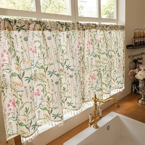 Detail of floral kitchen curtain with wildflower print and elegant white tassels