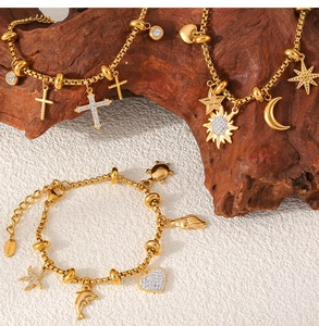 Detail view of gold stainless steel charms with sun moon stars and starfish motifs