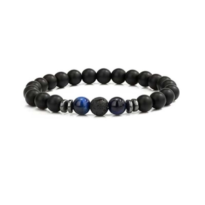 Detail view of 8mm matte black beads bracelet with blue tiger eye and lava stone accent