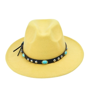 Detail of yellow wool felt fedora featuring black leather band with turquoise and silver studs