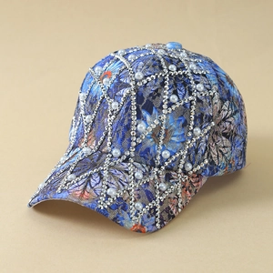 Detail of blue floral baseball cap with silver rhinestone grid and pearl accents