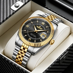 Detail of two-tone steel watch featuring fluted bezel and black dial in luxury gift box
