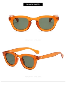 Detail view of orange retro sunglasses with green lenses and metallic rivet hinges