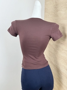 Rear view of a slim-fit dark brown crew neck T-shirt on a mannequin showing soft fabric texture