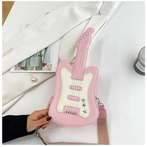 Detail of guitar-shaped pink crossbody bag with metal star studs and canvas strap