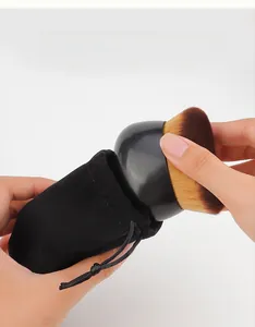 Detail view of large blending brush with a black velvet drawstring pouch for storage