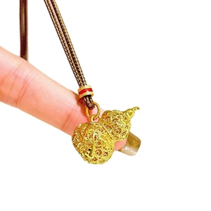 Handheld 24k gold plated hollow gourd pendant necklace with brown woven cord on white background