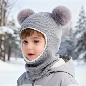 Gray baby knit balaclava with dual purple pom poms and warm fleece lining in snow