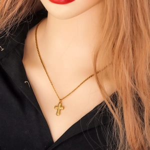 Golden textured cross necklace with O-chain on mannequin against black background