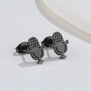 Detail view of pair of black retro microphone stud earrings on clean background