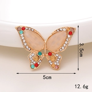 Dettaglio charm a farfalla con dimensioni 5cm x 3.5cm e strass multicolori scintillanti