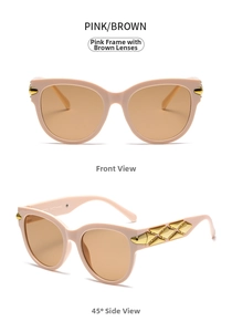 Detail of pink cat-eye sunglasses with golden diamond metal accents and brown lenses
