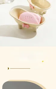 Detail of bathtub soap dish with pink bow decoration and drainage holes for bathroom