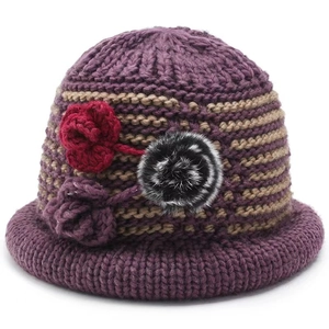 Deep purple winter knit cloche hat with thick thermal stripes and floral pompom detail