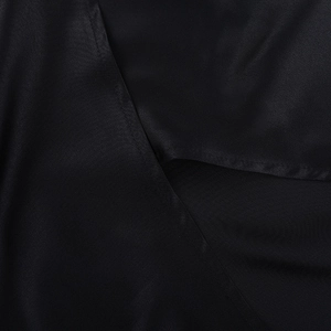 Detailed macro view of black satin fabric with smooth texture and soft silk-like luster