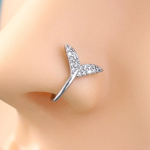 Detail of silver mermaid tail nose clip with sparkling rhinestones on female model nose