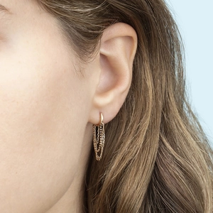 Close-up of golden tassel chain earrings worn by a model showcasing s925 silver needle