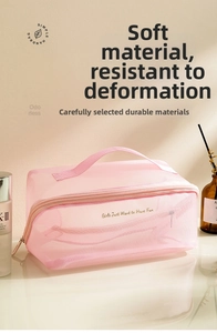 Detailed view of pink mesh toiletry bag with golden embroidery and convenient top handle