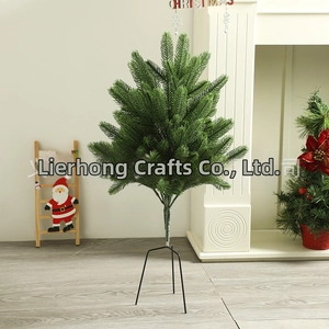 Detailed view of artificial Christmas tree with dense green needles and black metal stand