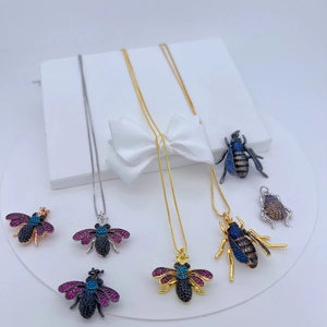 Detailed collection of insect jewelry with zircons on a white display with gift box