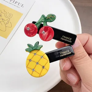 Cute fruit hair clips with cherry and pineapple designs and sparkling rhinestones