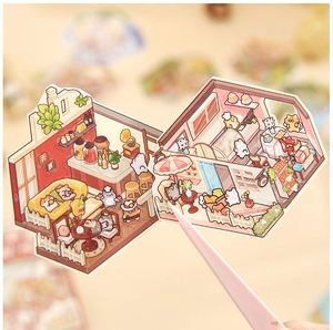 Close-up of cute cartoon interior room stickers being held with pink tweezers