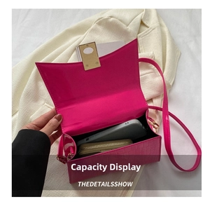 Detail showing the internal storage capacity of the pink crocodile embossed handbag