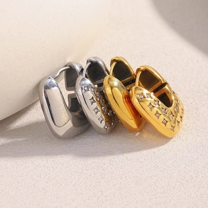 U-shaped gold and silver earrings featuring star-shaped diamond accents and a sleek finish