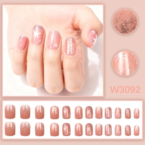 Winter press-on nail set in pink gradient with silver glitter and white snowflake patterns
