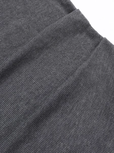 Macro shot of high-quality dark grey ribbed knit fabric showing texture and elasticity