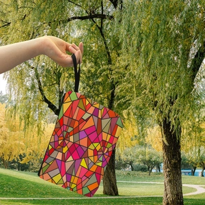 Colorful geometric mosaic makeup bag with zipper closure and black wristlet handle