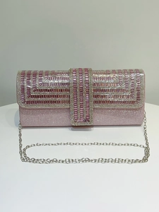 Close-up of pink glitter evening clutch with intricate rhinestone beadwork and silver chain