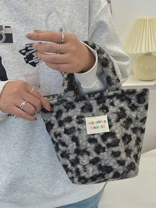 Chic gray leopard print plush handbag with soft faux fur texture and top handle
