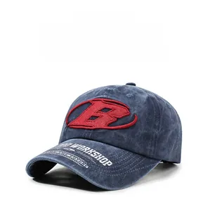 Détail de casquette vintage délavée avec broderie B rouge en relief et motifs sur la visière