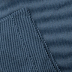 Close-up macro view of the deep blue ribbed knit corduroy fabric texture and fibers